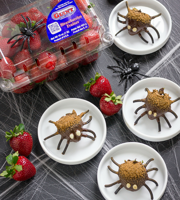 chocolate covered strawberries made to look like spiders by using pretzels as the spider legs