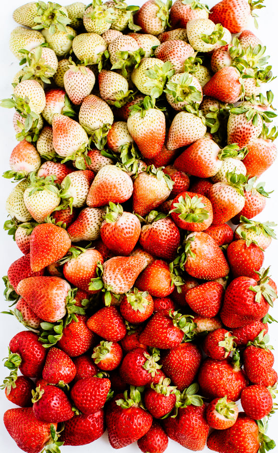 variety of strawberries with some being lighter than others