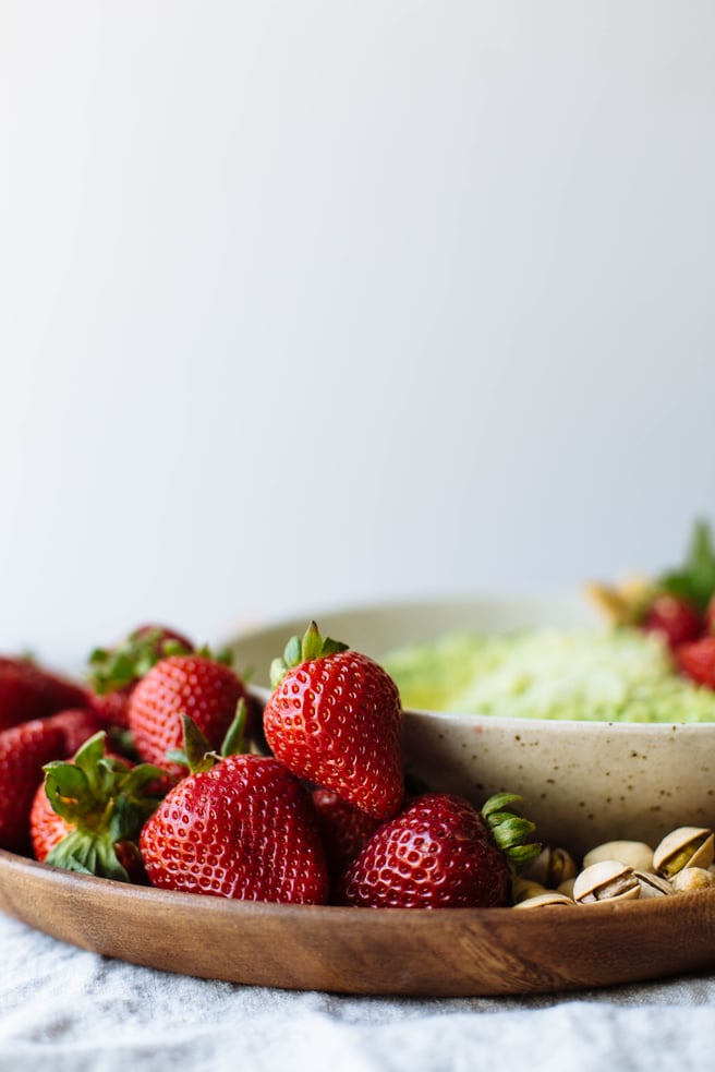 strawberries on the side of sweet pea hummus