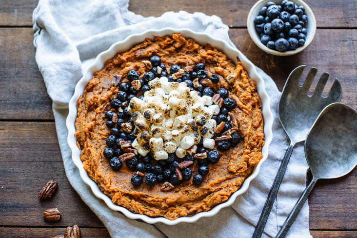 Sweet Potato Casserole topped with blueberries and marshmellows