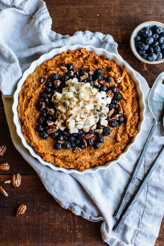 Sweet Potato Casserole topped with blueberries and marshmellows