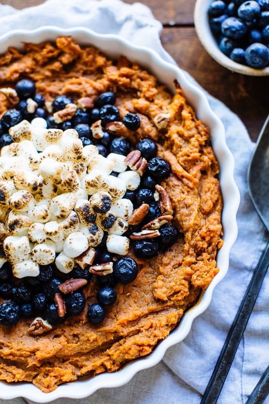 Sweet Potato Casserole topped with blueberries and marshmellows