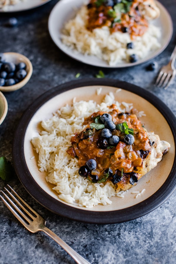 tikka masala on rice topped with blueberries