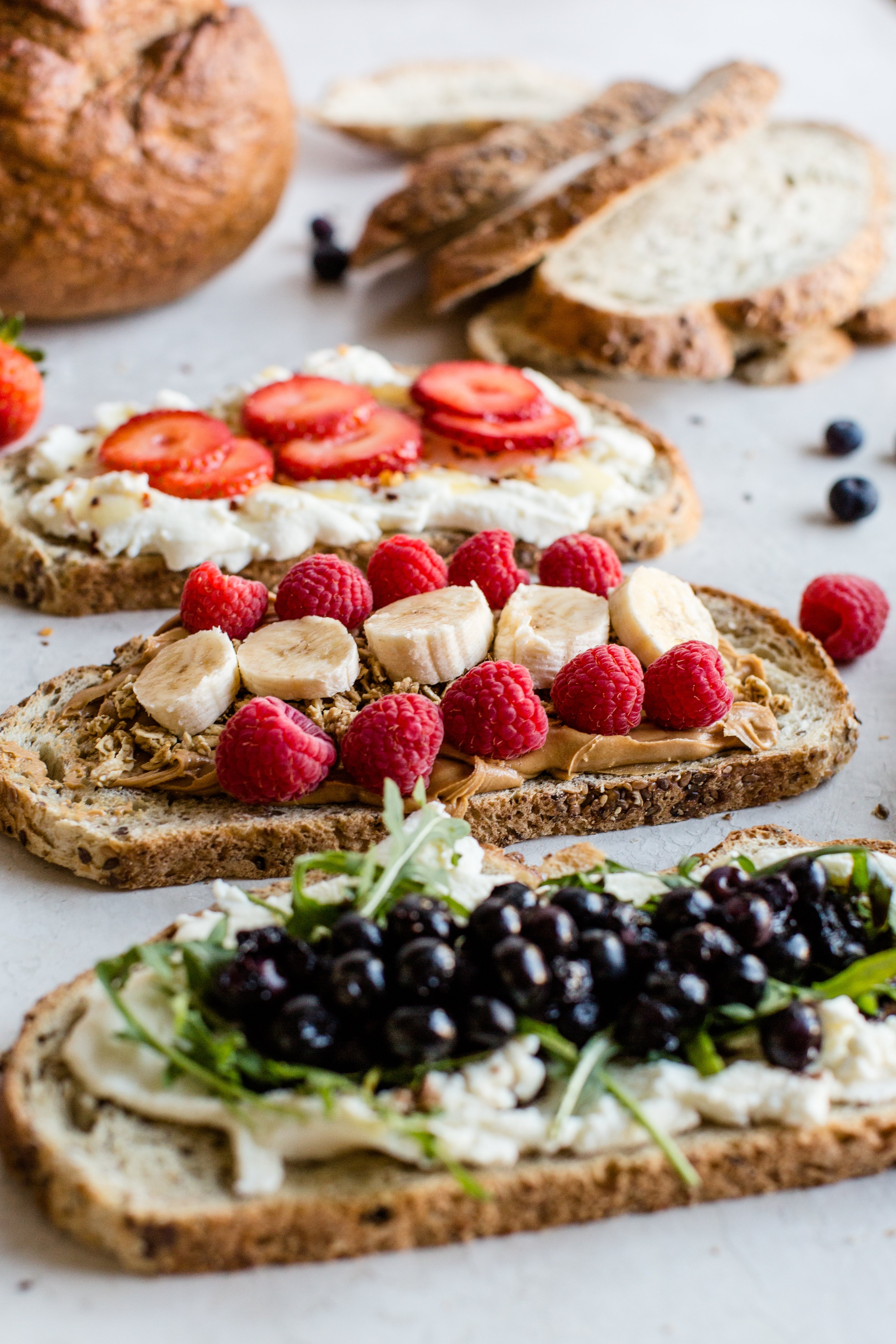 three different types of toast. All three are topped with berries