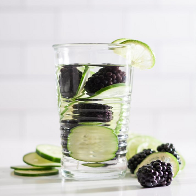 blackberries and thinly sliced limes in a glass of water