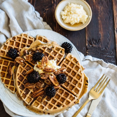 Waffles topped with blackberries and pecans